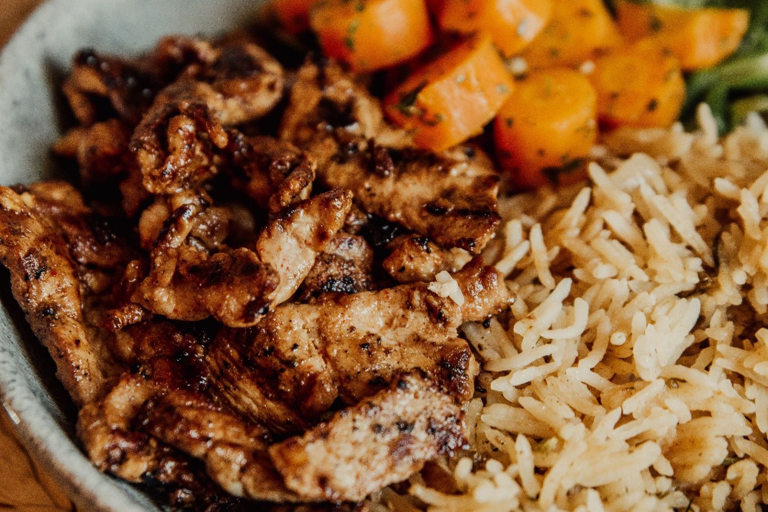 Balanced meal for a young footballer: rice, sliced chicken, carrots and salad