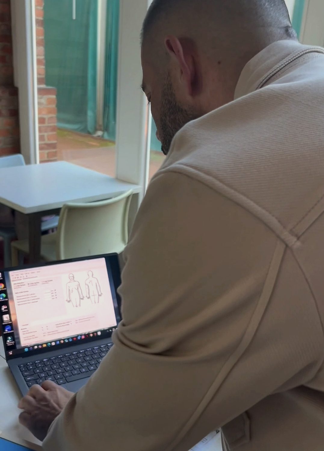 Jérôme Devos entering skinfold measurements to track body composition